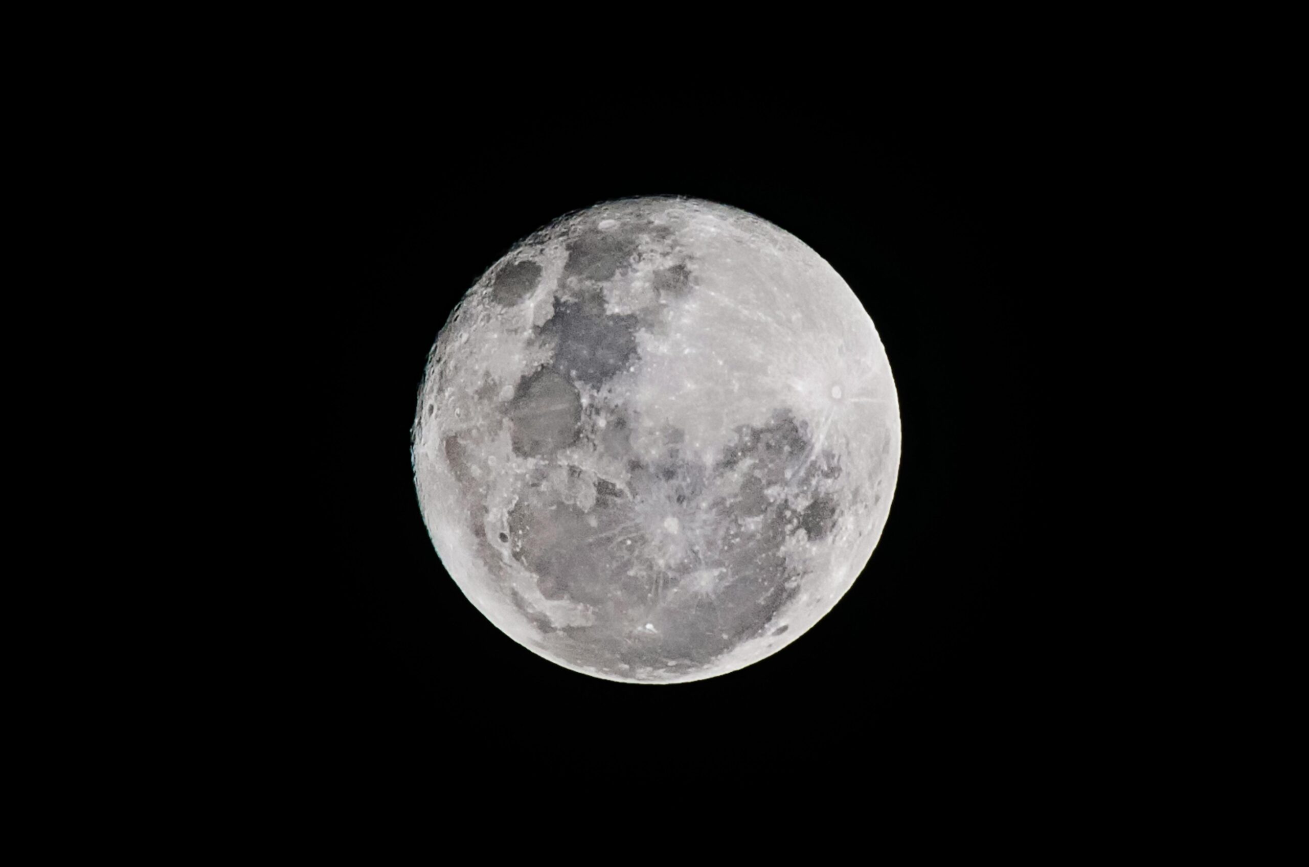 Detailed full moon captured against a black sky, showcasing lunar textures.